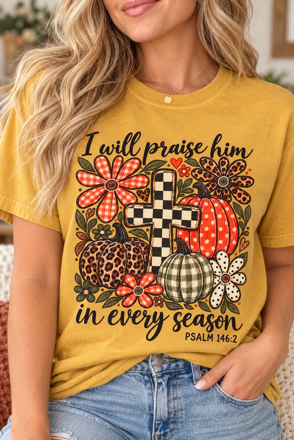 Model wearing a mustard Comfort Colors fall faith t-shirt with pumpkins, flowers, a checkerboard cross, and Psalm 146:2